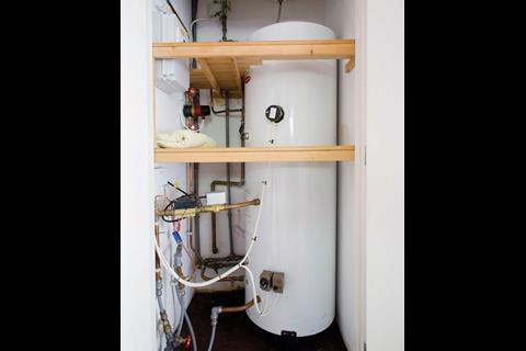 Hot water is supplied from the district heating system to hot water tanks in each home.